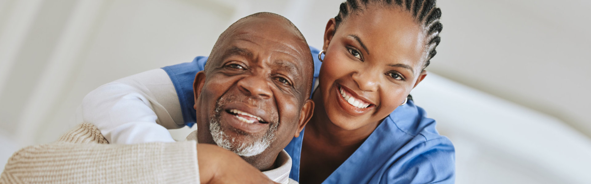 Senior man, nurse and hug portrait on a sofa for suppor