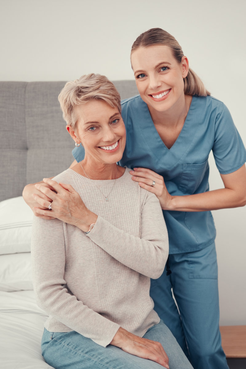 caregiver and elderly woman smiling