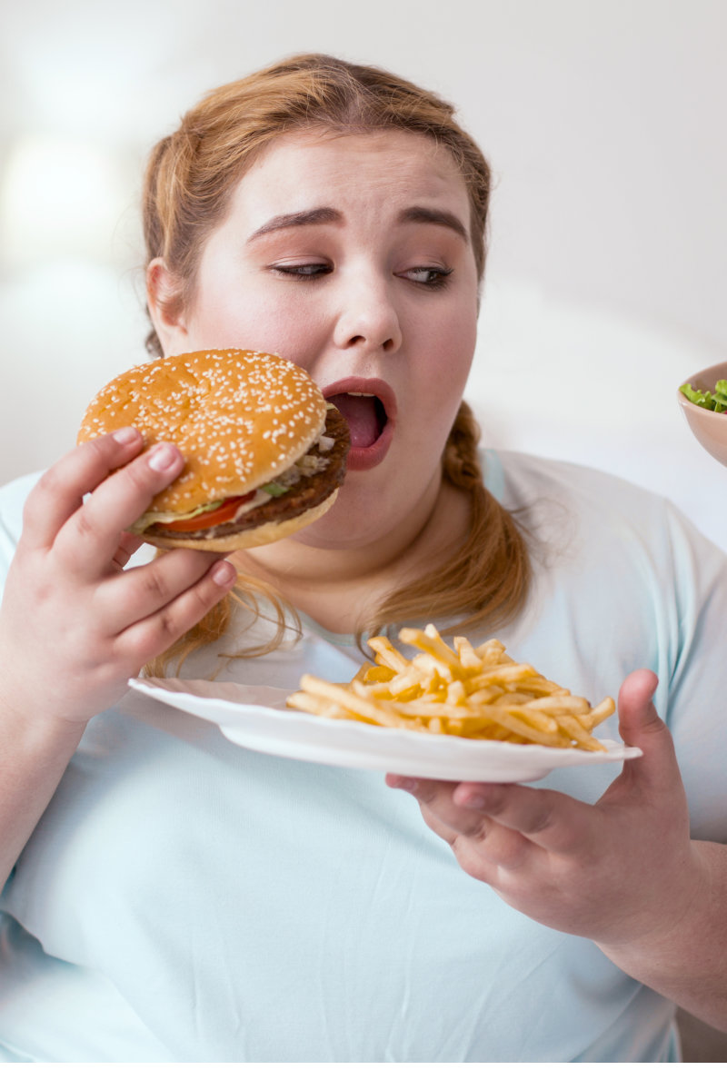 A woman eating unhealthy foods